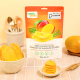 Dried Mango Slices 180 g pouch on a table with a bowl of mango slices and fresh mangoes