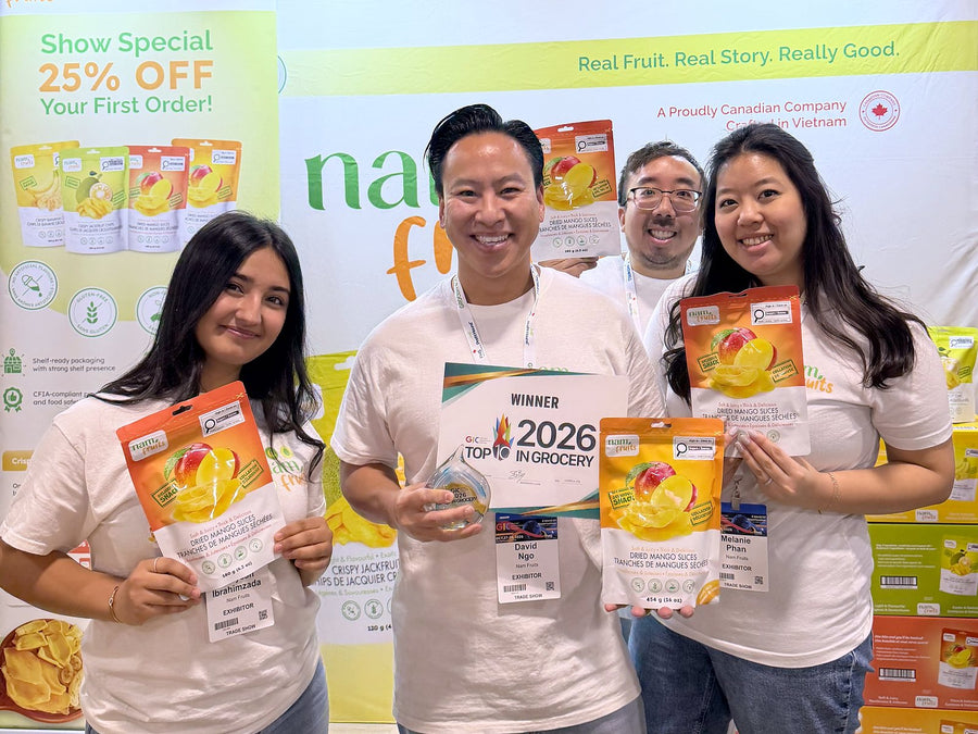 The Nam Fruits team at the GIC 2026 booth holding the winner sign and bags of Dried Mango Slices